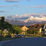a view of the snow capped mountains from a neigborhood in west jordan, ut