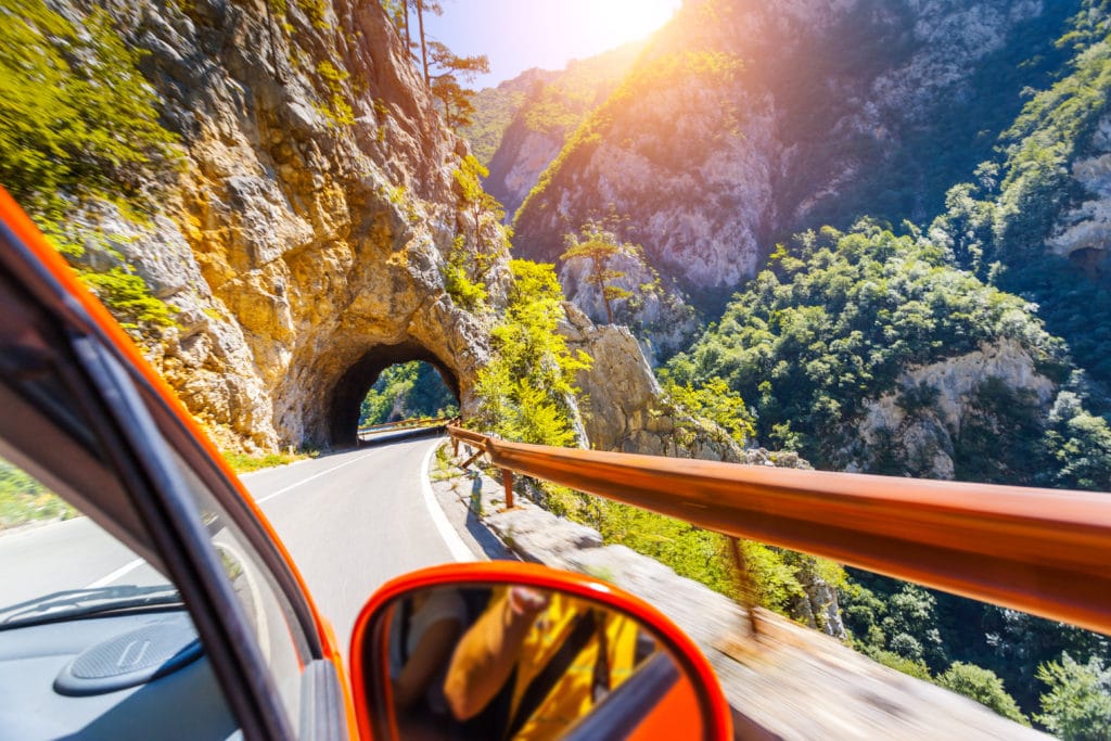 a car driving up a canyon to represent scenic drives in utah