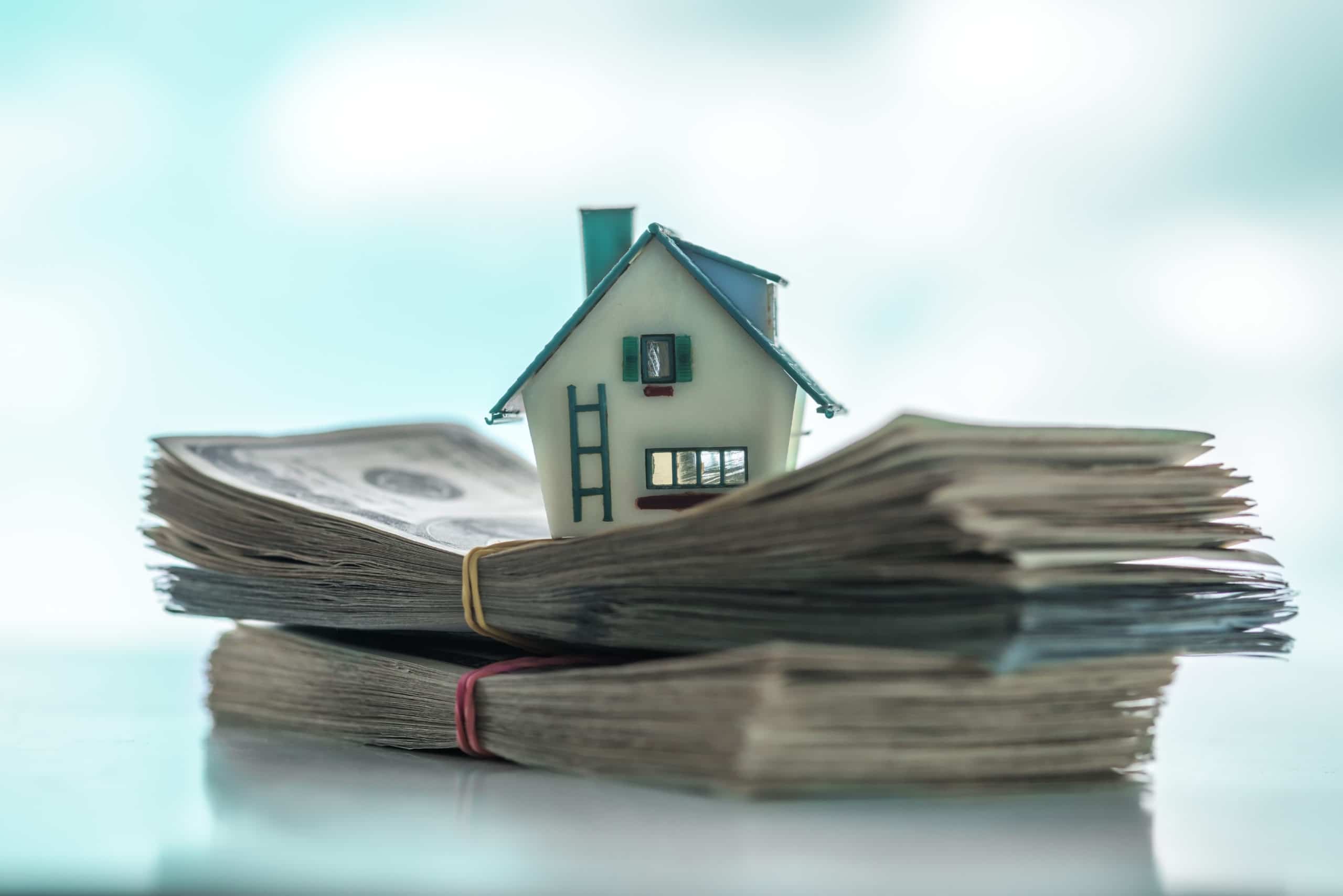 a home sitting on money to represent protecting your utah home down payment from inflation